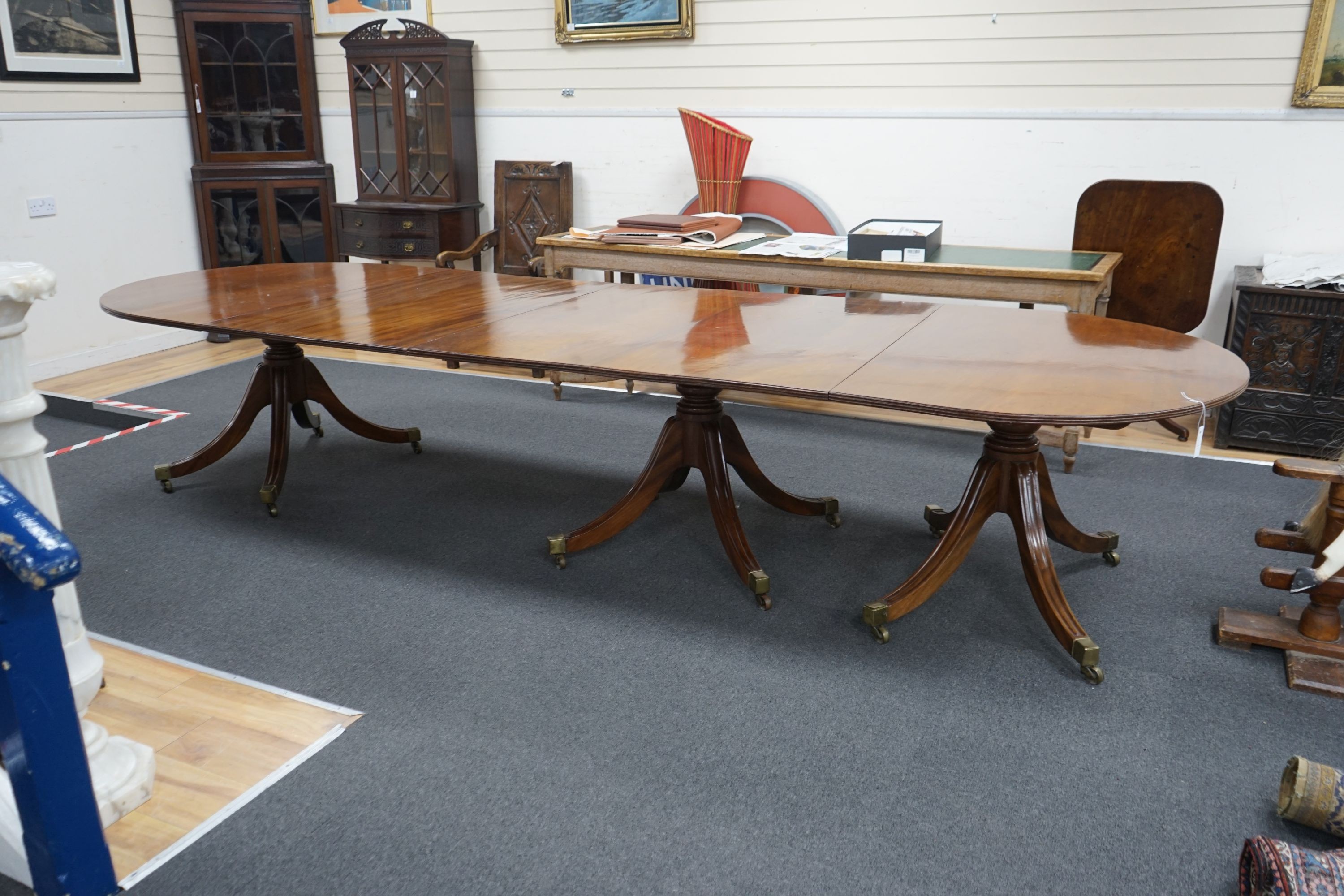 A George III and later mahogany three pillar D end extending dining table, one spare leaf, 376cm extended, width 128cm, height 72cm